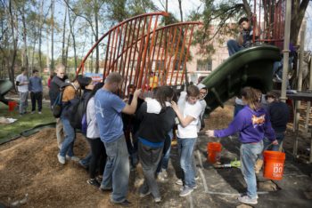 Some 100 Washington University volunteers helped construct a playground near KIPP Wisdom Academy. Reddin helped lead efforts to design the park. (Danny Reise/WUSTL Photos) 