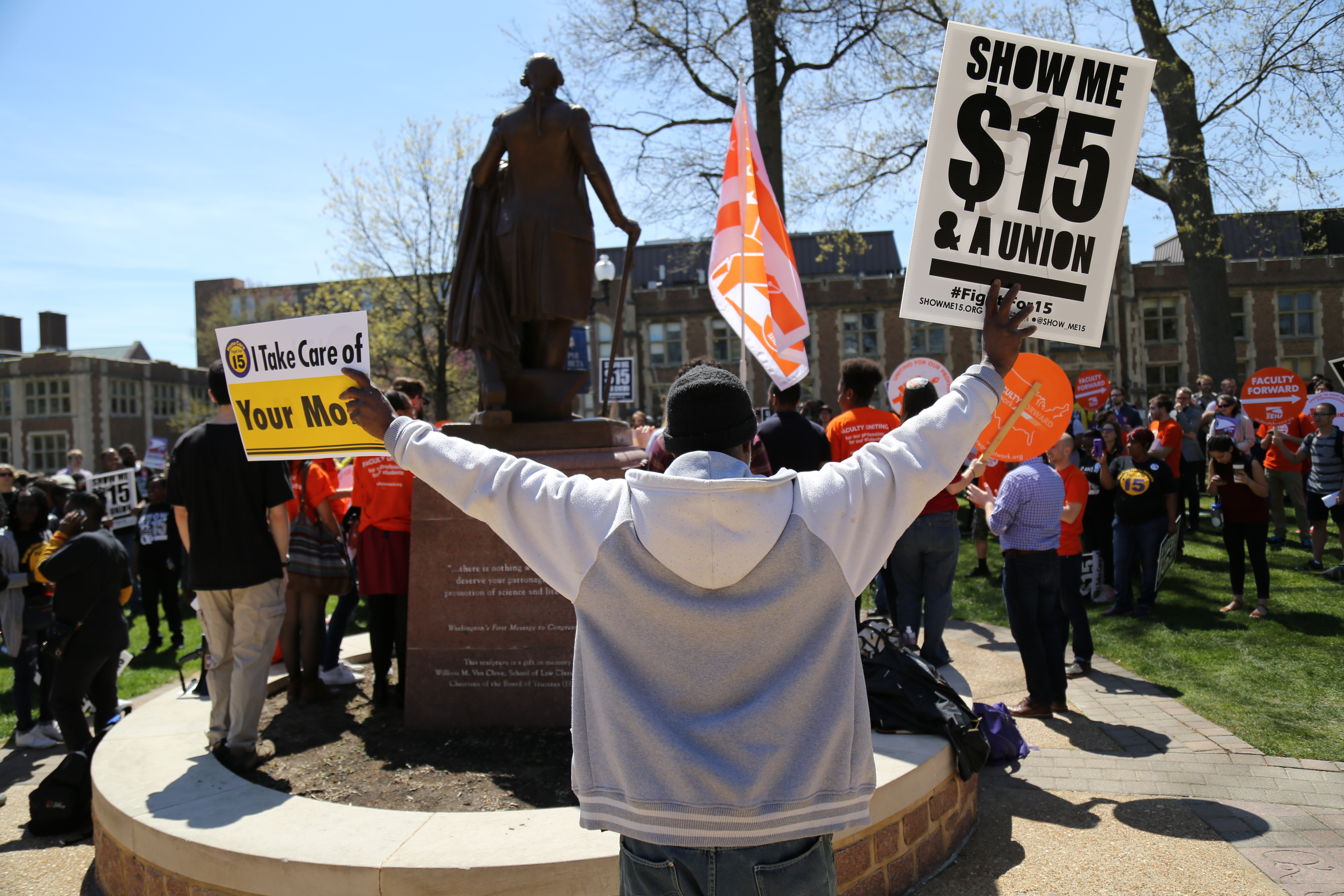 A protester holds up a sign for a $15 minimum wage outside Olin Library. Some of the most interesting events my photographers and I cover are rallies and protests on or near campus. Emotional rallies can be hard to cover because you want to balance good journalism with respect for people in the community.